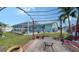 Relaxing patio with pergola, seating area and view of the pool at 1080 Piedmont Rd, Venice, FL 34293