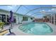 Inviting pool area with screened enclosure and patio furniture at 1080 Piedmont Rd, Venice, FL 34293