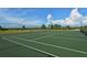 Two well-maintained tennis courts with a chain link fence at 1080 Piedmont Rd, Venice, FL 34293