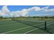 Tennis court with net, ready for a game at 1080 Piedmont Rd, Venice, FL 34293
