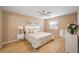 Bedroom with queen bed, ceiling fan and light wood flooring at 2300 Stickney Point Rd Rd # 104, Sarasota, FL 34231