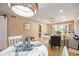 Bright dining area with white table and chairs, near living room at 2300 Stickney Point Rd Rd # 104, Sarasota, FL 34231