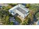 Overhead shot of a home with a well-maintained metal roof and inviting pool area surrounded by palm trees at 435 Partridge Cir, Sarasota, FL 34236