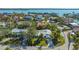 Aerial view of the home showcasing its location in a neighborhood surrounded by lush trees and water at 435 Partridge Cir, Sarasota, FL 34236