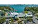 Aerial view of the community with waterfront access, boat docks, pool, and tennis courts at 435 Partridge Cir, Sarasota, FL 34236