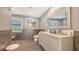 Clean bathroom featuring dual sinks, a large mirror and gray tile walls and flooring at 435 Partridge Cir, Sarasota, FL 34236