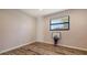 Cozy bedroom with wood-look floors and a bright window, offering a comfortable and relaxing space at 435 Partridge Cir, Sarasota, FL 34236