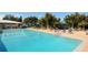 Large community pool surrounded by lush greenery and comfortable lounging areas at 435 Partridge Cir, Sarasota, FL 34236