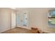 Light foyer features a glass front door, tile floors, and a basket for storage at 435 Partridge Cir, Sarasota, FL 34236