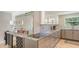 Modern kitchen with granite countertops, stainless steel appliances, wine storage, and mirrored accent wall at 435 Partridge Cir, Sarasota, FL 34236