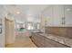 Bright kitchen with stainless steel appliances, granite countertops, and modern white cabinetry at 435 Partridge Cir, Sarasota, FL 34236