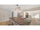 Bright kitchen features a granite countertop island and modern lighting, open to the dining area at 435 Partridge Cir, Sarasota, FL 34236