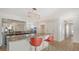 Open kitchen with granite countertops, stainless steel appliances, and bar seating with red chairs at 435 Partridge Cir, Sarasota, FL 34236