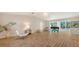 Spacious living area with tiled floors, a piano, contemporary furniture, and sliding doors to the outdoors at 435 Partridge Cir, Sarasota, FL 34236