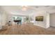 Bright living room with wood floors, neutral paint, and a view of the kitchen at 435 Partridge Cir, Sarasota, FL 34236