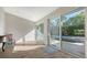 Bright living room featuring wood floors, neutral walls, and sliding glass doors to the pool area at 435 Partridge Cir, Sarasota, FL 34236