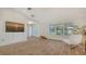 Bright living room with wood-look floors, neutral paint, and plantation shutters for natural light at 435 Partridge Cir, Sarasota, FL 34236