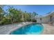 Relaxing pool surrounded by lush tropical landscaping, creating a private oasis for leisure and recreation at 435 Partridge Cir, Sarasota, FL 34236