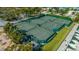 Well-maintained tennis courts with players and lush greenery for privacy at 435 Partridge Cir, Sarasota, FL 34236