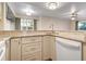 Modern kitchen features granite countertops, light cabinets, and a built-in dishwasher at 850 S Tamiami Trl # 701, Sarasota, FL 34236