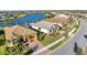 Aerial view of neighborhood with houses and lake at 13005 Rinella St, Venice, FL 34293