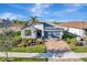 One-story house with gray garage door and landscaped yard, aerial view at 13005 Rinella St, Venice, FL 34293