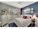 Serene bedroom featuring a blue accent wall and comfy bedding at 13005 Rinella St, Venice, FL 34293