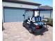 Rear view of blue golf cart with white and blue striped seats at 13005 Rinella St, Venice, FL 34293