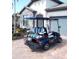 Rear view of blue golf cart with white and blue striped seats at 13005 Rinella St, Venice, FL 34293