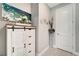 Hallway with white cabinet and tall vase at 13005 Rinella St, Venice, FL 34293