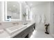 Elegant bathroom with double vanity and illuminated mirrors at 1990 Main St # Ph 6, Sarasota, FL 34236