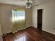 Well-lit bedroom with wood flooring and ceiling fan at 25692 Aysen Dr, Punta Gorda, FL 33983