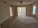 Bright bedroom featuring sliding glass doors to balcony at 25692 Aysen Dr, Punta Gorda, FL 33983