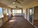 Spacious Florida room with sliding glass doors and ceiling fans at 25692 Aysen Dr, Punta Gorda, FL 33983