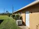 House exterior showcasing a side door and AC unit at 25692 Aysen Dr, Punta Gorda, FL 33983