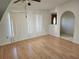 Living room featuring laminate floors and arched entryway at 25692 Aysen Dr, Punta Gorda, FL 33983