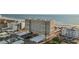 Aerial view of beachfront condo building with ocean and surrounding buildings at 6140 Midnight Pass Rd # 407, Sarasota, FL 34242