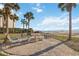 Outdoor patio with BBQ grill and seating near the beach at 6140 Midnight Pass Rd # 407, Sarasota, FL 34242