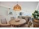 Bright dining area with a round table and wicker chairs at 6140 Midnight Pass Rd # 407, Sarasota, FL 34242