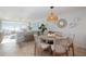 Charming dining area with a round table and wicker chairs at 6140 Midnight Pass Rd # 407, Sarasota, FL 34242