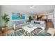 Bright living room with comfy sofas, coffee table, and ocean-themed art at 6140 Midnight Pass Rd # 407, Sarasota, FL 34242