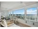 Stunning ocean view from sunroom with seating and small table at 6140 Midnight Pass Rd # 407, Sarasota, FL 34242