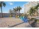 Relaxing patio area with colorful chairs and palm trees at 6140 Midnight Pass Rd # 407, Sarasota, FL 34242