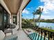 Balcony with water views and outdoor seating at 65 Lighthouse Point Dr, Longboat Key, FL 34228