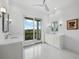 Bathroom with white vanity and water views at 65 Lighthouse Point Dr, Longboat Key, FL 34228