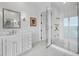 Elegant bathroom with white vanity, gold fixtures, and a large glass shower at 65 Lighthouse Point Dr, Longboat Key, FL 34228