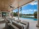 Spacious covered patio with multiple seating areas and stunning water views at 65 Lighthouse Point Dr, Longboat Key, FL 34228