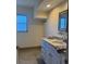 Bathroom with granite countertop and white cabinets at 6725 Roxbury Dr, Sarasota, FL 34231