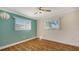 Bedroom with wood-look floors and two windows at 6725 Roxbury Dr, Sarasota, FL 34231