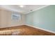 Well-lit bedroom with wood-look floors and a window at 6725 Roxbury Dr, Sarasota, FL 34231